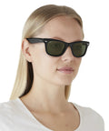 Woman wearing Unisex Wayfarer Style Sunglasses With Low Bridge Fit, Iconic Square Frames, UV Protection, G-15 Green, 52mm.