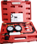 Front view of red tool case opened to reveal a dual-gauge cylinder leak-down tester kit with hoses and fittings.