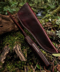 Fixed Blade Knife With Rosewood Handle And Leather Sheath For Outdoor Use VG10 Steel Blade on forest floor scene