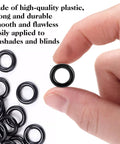 One Hundred Black Plastic Roman Blind Curtain Rings O Rings For Window Treatments Smart Cord Guides shown in hand for easy handling.