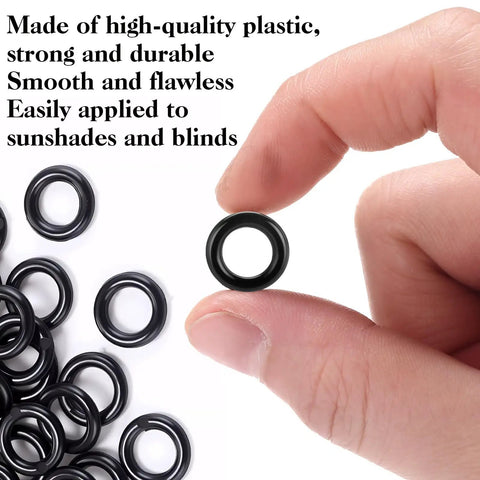 One Hundred Black Plastic Roman Blind Curtain Rings O Rings For Window Treatments Smart Cord Guides shown in hand for easy handling.