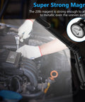 Dual COB And Flashlight LED Work Light used in car engine repair, showing magnetic base attachment.