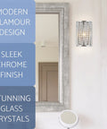 Mirror with modern wall sconce featuring sleek chrome finish and stunning glass crystals, adjacent to a round vanity mirror.