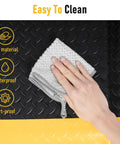 Close-up of a hand cleaning Extra Thick 3 By 7 Ft Anti Fatigue Floor Mat For Standing Tasks In The Shop Or Garage Ergonomic Comfort