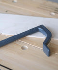 8 Inch Bench Holdfast Clamps for Woodworking, Heavy Duty Hold Downs, close-up of steel clamp on woodwork bench with dog holes