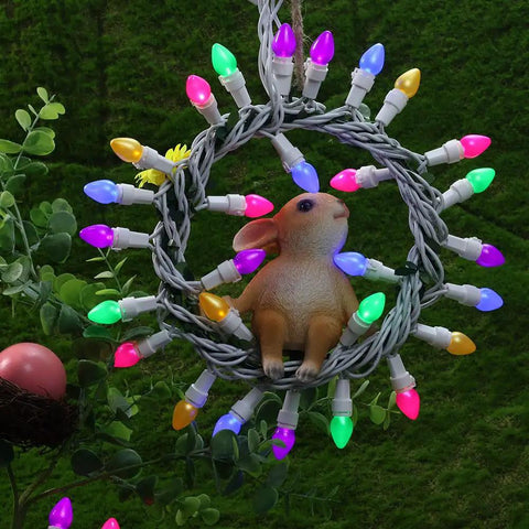 Easter String Lights LED Multi Color Glass C3 Bulbs 50 Count on white wire with a decorative rabbit in center, outdoor setting.