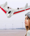 2.4GHz Ready To Fly RC Plane For Beginners With 3-Axis Gyro Auto Stabilization flying over a child outdoor