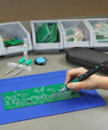 Using a Portable Soldering Iron Pen Kit With 65W PD QC Type C Power on a circuit board, rapid 5 second heat up, blue mat surface.
