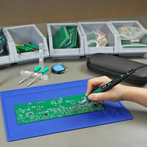Using a Portable Soldering Iron Pen Kit With 65W PD QC Type C Power on a circuit board, rapid 5 second heat up, blue mat surface.