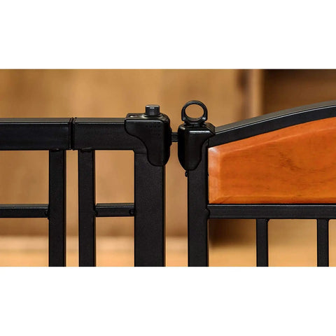 Close-up of Walk Through Pet Gate With Cherry Wood Accents And Black Finish, sturdy metal frame detail, pressure mount