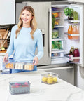 Woman using Three Piece Refrigerator Organizer Set With Lids For Fresh Produce And Storage, Clear And Gray Bins To Keep Your Fridge Neat.