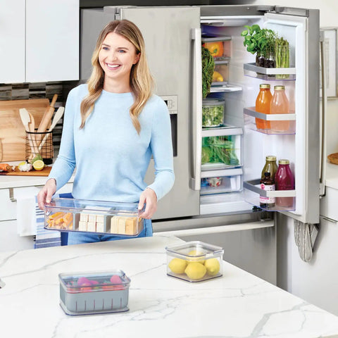 Woman using Three Piece Refrigerator Organizer Set With Lids For Fresh Produce And Storage, Clear And Gray Bins To Keep Your Fridge Neat.