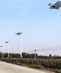 Rock Solid Solar LED Flood Lights With Motion Sensor And Hella Bright 600W Output Wireless Remote IP65 Weatherproof Outdoor Security Wall Lamp For Yard Or Driveway line of solar lights along a rural road under clear sky