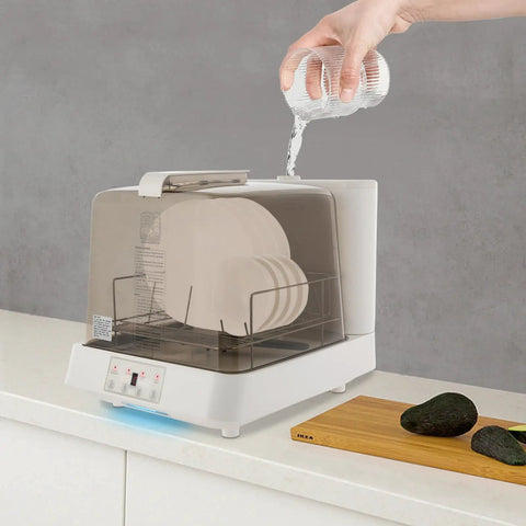 Portable Countertop Mini Dishwasher With 360 Degree Rotating Spray Heads And 1.59 Gallon Tank pouring water into appliance with clean plates visible.