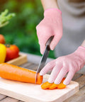 Person slicing carrot wearing Cut Resistant Kitchen Gloves Level 5 Food Grade Protection For Safe Food Prep Small Pink HPPE Gloves