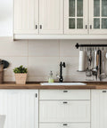 Modern kitchen with white cabinets featuring 30 Pack 2 Inch Square Cabinet Pulls Matte Black Stainless Steel Kitchen Drawer Pulls.