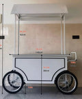 Slick Portable Vendor Cart With Heavy Duty Rubber Wheels And Locking Storage Cabinet For Farmers Markets Pop Up Booths And Flower Display Racks standing next to a wall, showing dimensions and solid design.