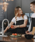 Top Shelf Kitchen Faucet With Pull Down Sprayer In Brushed Nickel Lead Free Stainless Steel Build Rated For Heavy Duty Use And Turning Sink Cleanup Into A Snap with a woman cooking.