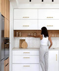 Modern kitchen with Champagne Bronze Cabinet Pulls 5 Inch 128mm 10 Pack for Kitchen Cabinets and Drawers, installed on white cabinetry.