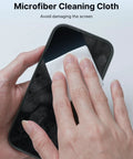 Microfiber cleaning cloth, white, for smartphone screens; close-up of hand wiping a phone.