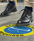 Five Pack Safety Glasses Required Signs 17 by 17 Inches Self Adhesive Vinyl Waterproof Eye Protection Caution Warning Signage for Shop Floor Factory Warehouse Workplace displayed on floor with person standing
