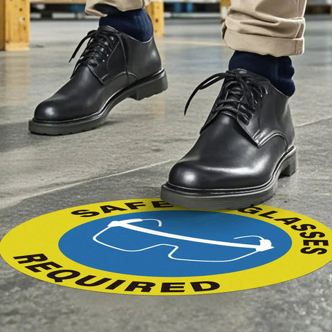 Five Pack Safety Glasses Required Signs 17 by 17 Inches Self Adhesive Vinyl Waterproof Eye Protection Caution Warning Signage for Shop Floor Factory Warehouse Workplace displayed on floor with person standing