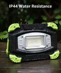 Portable LED Work Light 20W Rechargeable Flood Light With Built In Power Bank placed outdoors showcasing IP44 water resistance