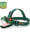 Totally Rad LED Dinosaur Headlamp For Kids With Roar Sound And 3 Lighting Modes T Rex Shape Toy Flashlight shown with packaging