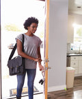 Woman entering kitchen with Sixteen Pack Silicone Door Stopper With Suction Cup Silent Door Stop Easy To Install For Kitchen And Office Use