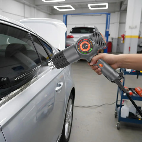 Using Beast 1800W Heat Gun With Fast Heating, LED Temperature Display In Three Colors on car film in garage.