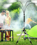 Standing misters for outdoor cooling on the go with four spray heads near a BBQ and camping tent