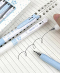 Four Pack Cute Retractable Gel Pens Blue Star 0.5mm Fine Point Black Ink Smooth Writing shown on lined notebook paper
