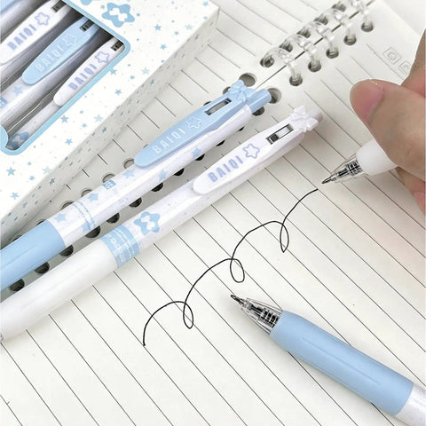 Four Pack Cute Retractable Gel Pens Blue Star 0.5mm Fine Point Black Ink Smooth Writing shown on lined notebook paper