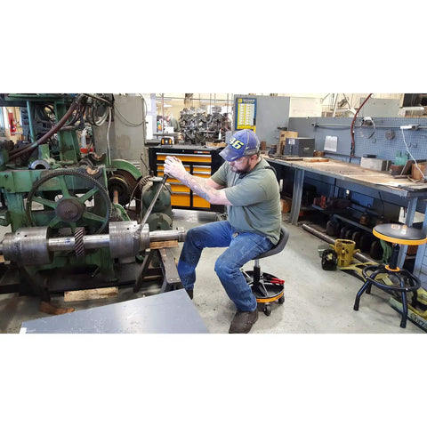 Person using Adjustable Height Swivel Mechanics Seat for 18 to 22 Inches 360 Degree Spin Solid Rubber Seat in garage workshop