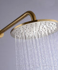 High End Bathroom Flex With This 12 Inch Round Shower System Built From Rock Solid Brass And Sporting Sleek Brushed Gold Wall Mounted Rainfall Mixer Valve Combo Kit With Straight Silicone Nozzle For Ultimate Spa Luxury - Closeup of brushed gold shower head with flowing water.