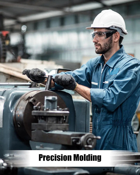 Worker in blue coveralls operating machinery for precision molding in a metalworking shop