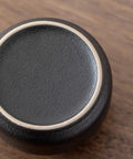 Top view of a snug wooden lid for Elevate Your Kitchen Stash With These Top Shelf Ceramic Tea Canisters set of 4.