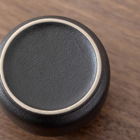 Top view of a snug wooden lid for Elevate Your Kitchen Stash With These Top Shelf Ceramic Tea Canisters set of 4.