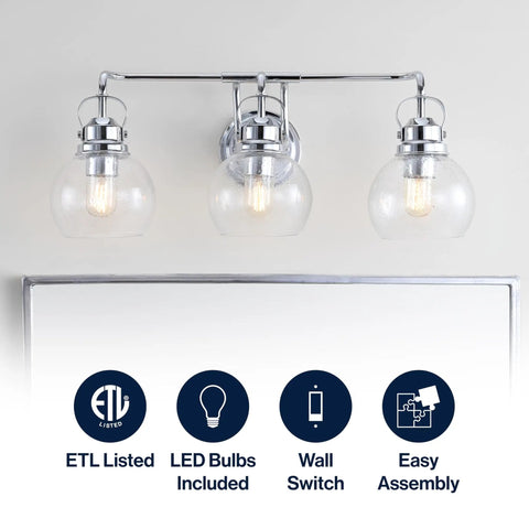 Chrome Three Light Bathroom Vanity Light With Clear Seeded Glass Shades, wall sconce above mirror showing LED bulbs included.