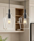 Kveosv 2 Pack Kitchen Island Pendant Lights, 8" Clear Glass Shade, black metal fixtures in a modern kitchen setting.