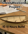 Wooden Model Boat Building Kit For Beginners, All In One Starter Set With Tools Glue And Paint, 1 To 12 Scale Dinghy on table.