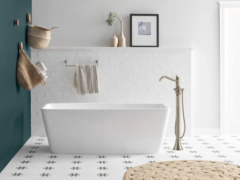 Freestanding Tub Filler Kit with Single Riser for Floor Joist Concrete Mounting seen next to a white freestanding bathtub