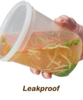 32 Oz Deli Style Food Storage Containers With Lids Pack Of 24 For Grab And Go Takeout And Meal Prep Leak Proof Freezer Safe Microwaveable Soup Containers Clear BPA Free Heavy Duty Plastic Stackable And Reusable held at an angle, showing leak-proof feature with soup inside.