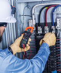 Electrician using Digital Clamp Meter With True RMS And LoZ Auto Ranging For AC And DC Voltage And Current Continuity Frequency