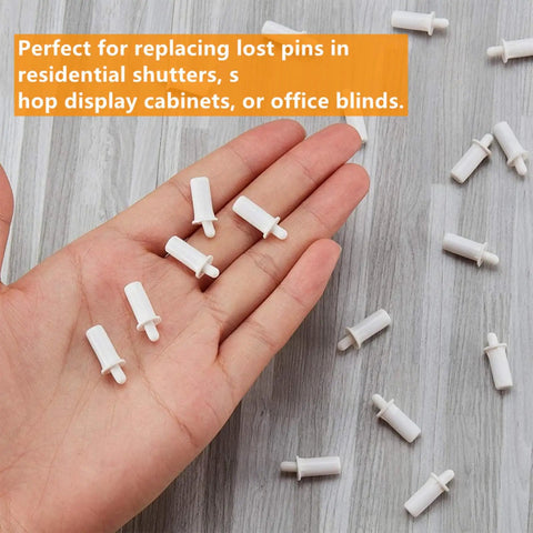 No Grunt Work Needed Spring Loaded Shutter Repair Pins For Plantation Blinds 30 Piece Replacement Kit in a hand on wooden surface.