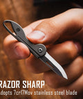 Mini Titanium Pocket Knife For Everyday Carry With Razor Sharp Folding Blade shown being held by hand