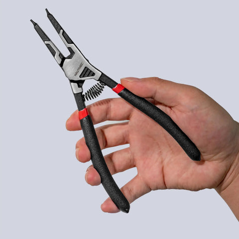 Hand holding Pro-Grade 4-Piece High Leverage Snap Ring Pliers Set tool, 7-inch with spring-loaded handles, chrome vanadium steel.
