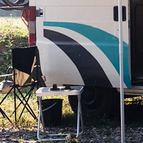 Tough Black Nylon Rv Door Catch Retainer Hook Replacement For Your Motorhome Or Camper on a camping table next to a chair.