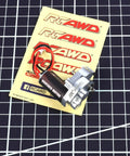 RCAWD brushed motor with red/black wires and aluminum gear case on yellow RC AWD card, front view