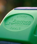 Close-up of the 37 Gallon Dual Chamber Tumbling Composter For Backyards with "START" embossed on green panel, showing outdoor use.